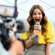 Drew Barrymore smiling holding a microphone